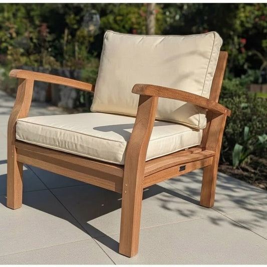 Deep wooden garden armchair with magnolia cushions on a patio