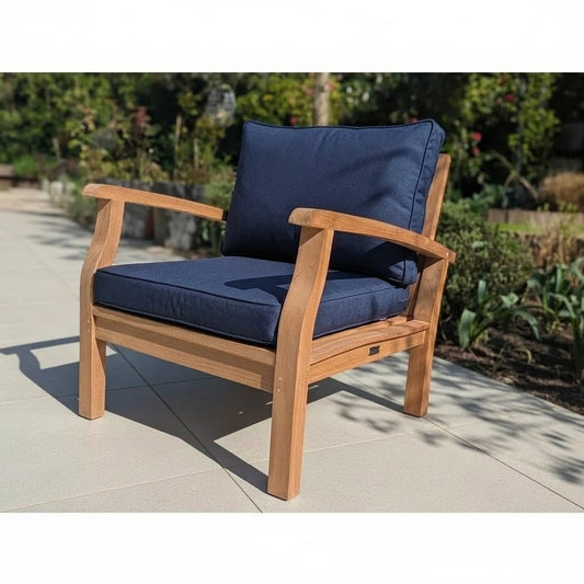 Wooden outdoor sofa chair with navy cushions on a patio