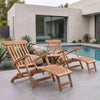 A pair of wooden outdoor teak steamer chairs on a tiled patio beside a pool with plants and rocks in the background.