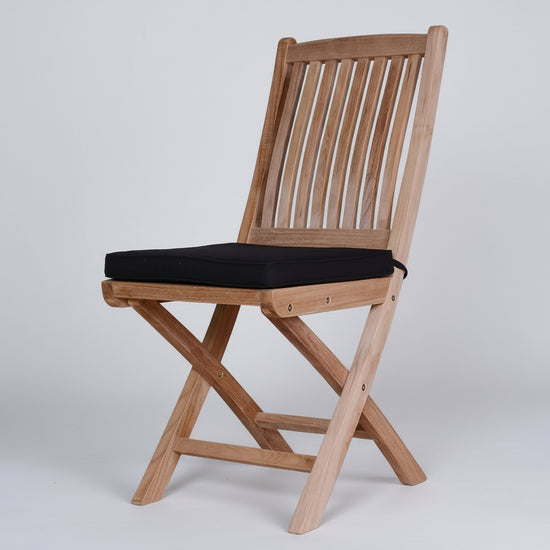 high quality Wooden teak folding chair with a black cushion on a white background