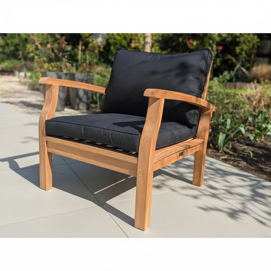 Wooden outdoor sofa with black cushions on a patio
