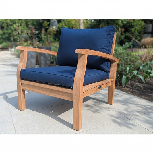 Wooden outdoor chair with blue cushions on a grey patio