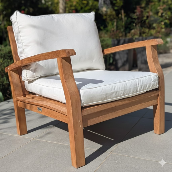 Wooden outdoor chair with white cushions on a stone patio