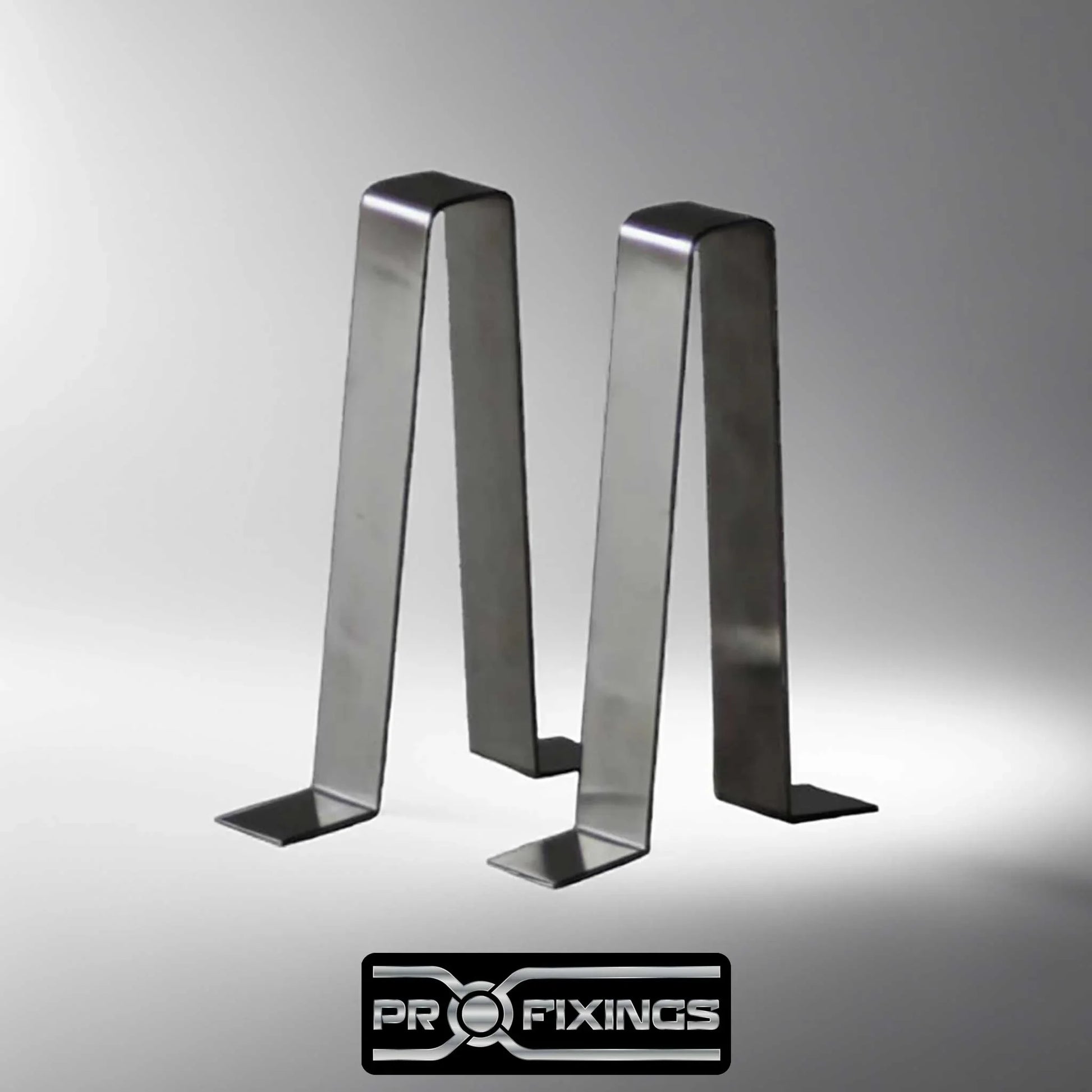 a pair of stainless steel garden bench braces in a grey studio setting