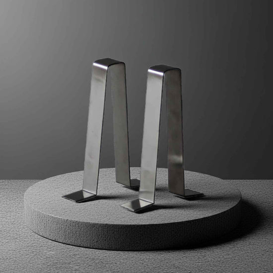 stainless steel garden bench braces on a concrete plinth