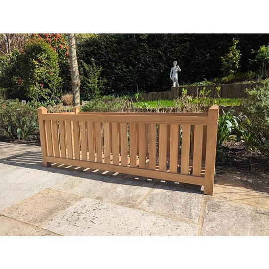 Versailles teak wood planter box in a garden setting with a statue in the background