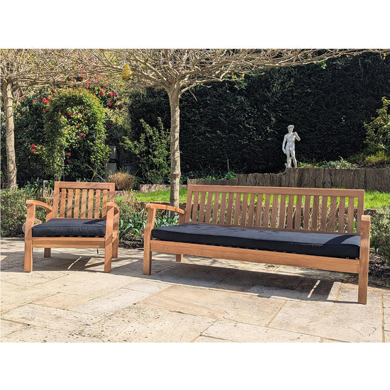 Wooden outdoor furniture set in black cushions with bench and chair on a patio
