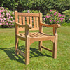 teak garden armchair, Sandhurst, with scroll arms in a garden setting on a lawn
