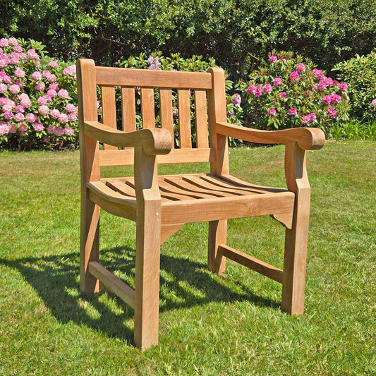 teak garden armchair, Sandhurst, with scroll arms in a garden setting on a lawn