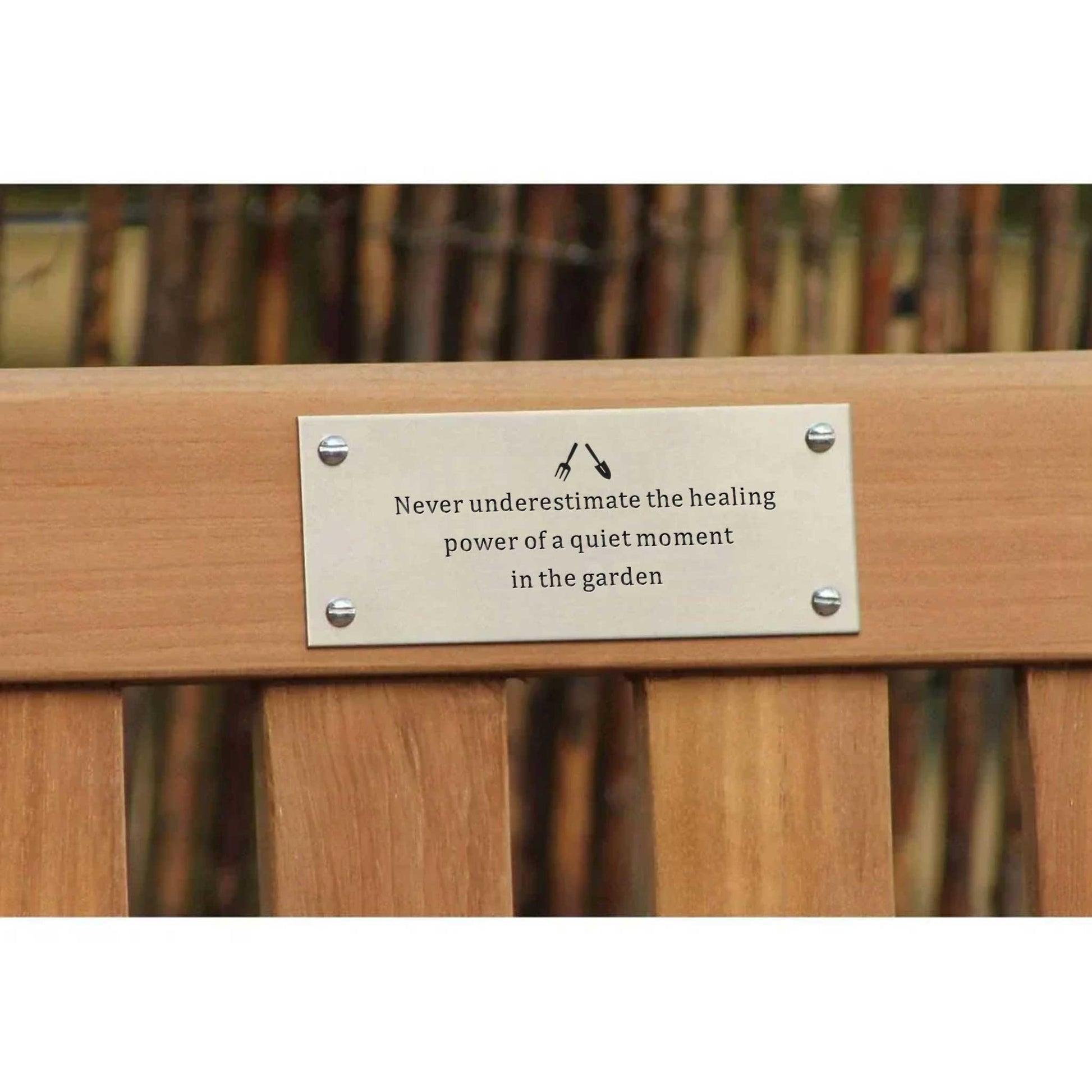 Wooden bench with a metal plaque in a garden setting