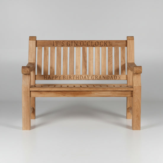 Wooden garden bench with engraved text on a white background