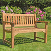 Wooden garden 2-seat Farleigh bench on grass with pink flowers and greenery in the background