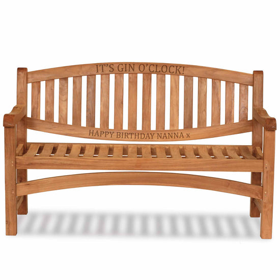 Wooden oval teak garden bench with engraved text on a white background