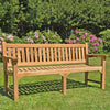Wooden teak garden bench, 4 seat Farleigh, in a garden setting on a lawn