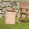 Wooden outdoor Serving Platter and Garden Side Stand against a stone wall