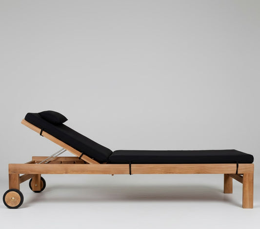 Teak wood sun lounger, with wheels,  black cushions white background