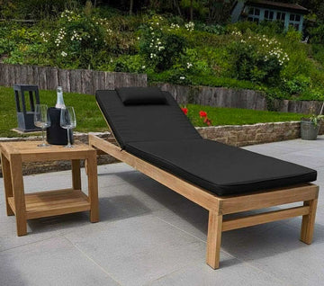 teak garden sun longer with wheels and a black cushion on grey ceramic tiles
