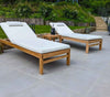 pair of teak garden sun loungers on grey ceramic tiles