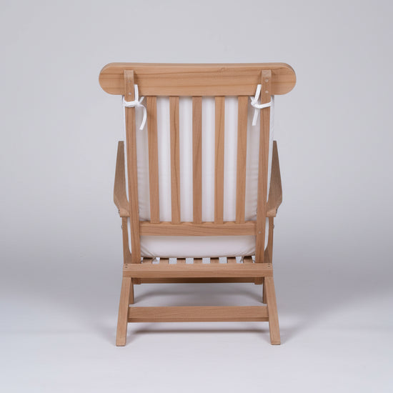 Wooden chair with white cushion on a white background