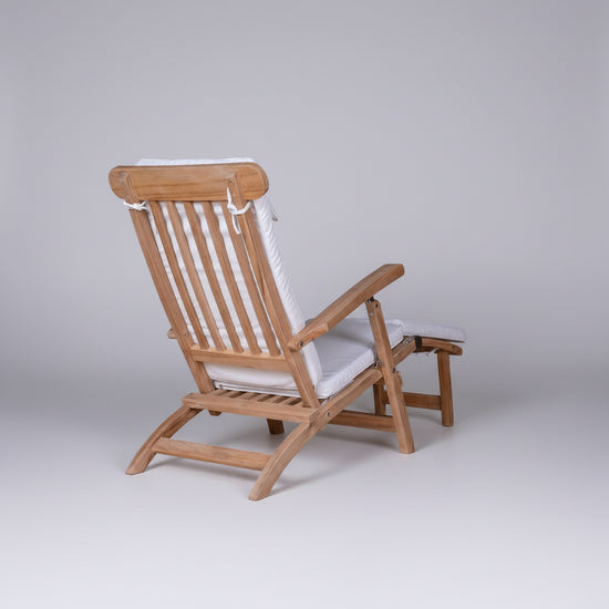 Wooden deck chair with white cushions on a white background