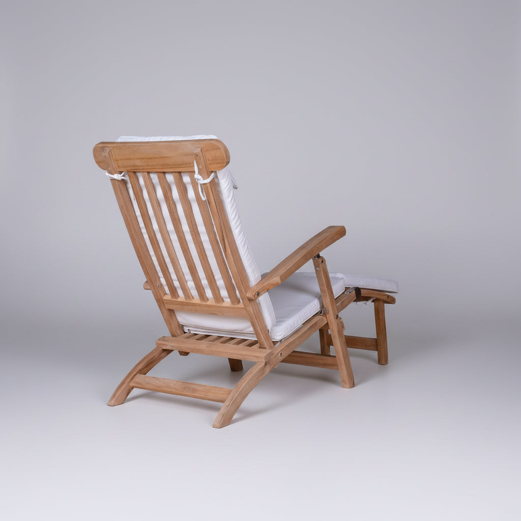 Wooden deck chair with white cushions on a white background