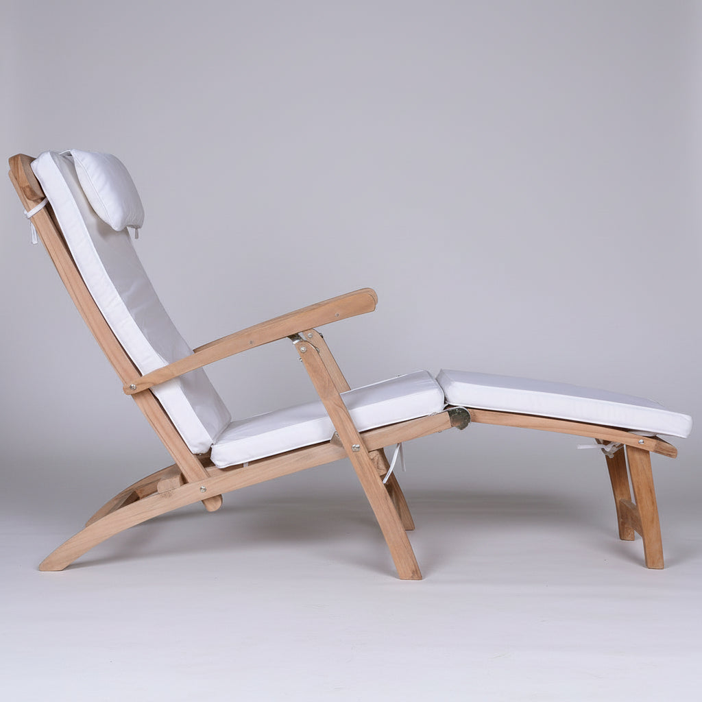 Wooden steamer chair with white cushions on a white background