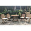 Wooden folding round outdoor table with four matching chairs, white cushions, on a