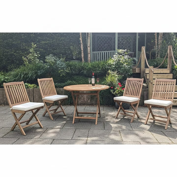 Wooden folding round outdoor table with four matching chairs, white cushions, on a