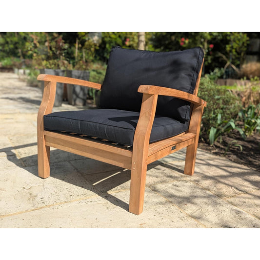 Wooden outdoor sofa with black cushions on a patio